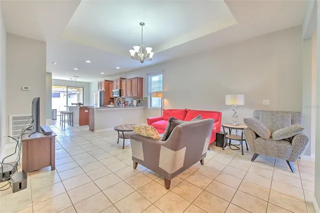 a living room with furniture and kitchen view