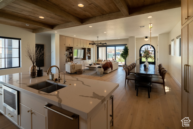5366 Cyan Lane St. George, UT 84790 - Photo 39 of 39 Kitchen featuring open floor plan, recessed lighting, light wood-type flooring, stainless steel microwave, and dishwashing machine