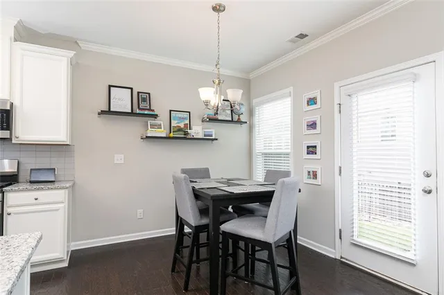a view of a dining room with furniture and window
