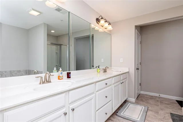 a bathroom with a double vanity sink mirror and