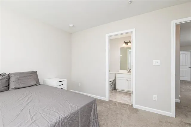 a bedroom with a bed and bathroom