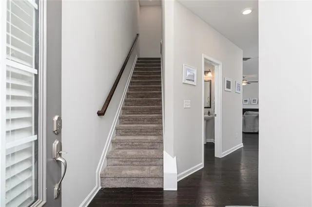 a view of a hallway with wooden floor and entryway