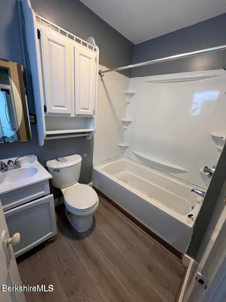 98 Lincoln Street, Unit A Pittsfield, MA 01201 - Photo 9 of 11 a bathroom with a toilet a sink and bathtub