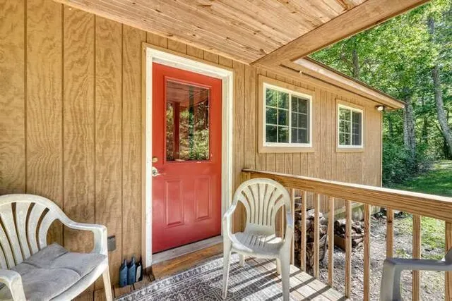 a kitchen with stainless steel appliances granite countertop a refrigerator a sink dishwasher a stove and white countertops with wooden floor