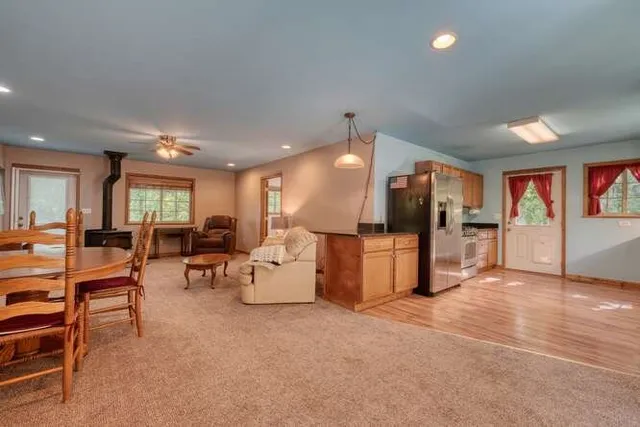 a kitchen with stainless steel appliances granite countertop a refrigerator a sink and a stove