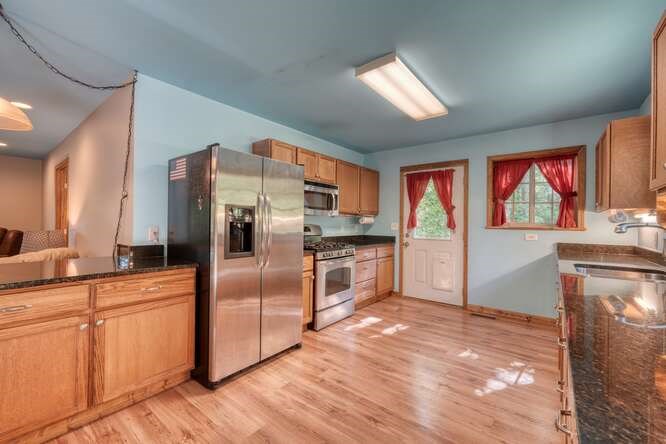 441 Foxfire Road Blairsville, GA 30512 - Photo 17 of 73 a kitchen with stainless steel appliances granite countertop a refrigerator a sink and a stove