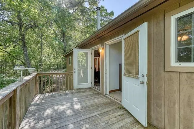 a bedroom with a bed and a flat tv screen on dresser
