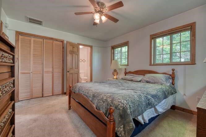 441 Foxfire Road Blairsville, GA 30512 - Photo 25 of 73 a bedroom with a bed and a chandelier