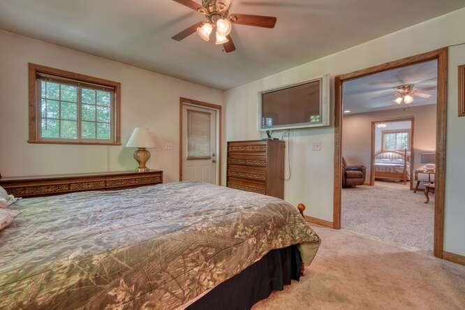 441 Foxfire Road Blairsville, GA 30512 - Photo 27 of 73 a bedroom with a bed and a chandelier