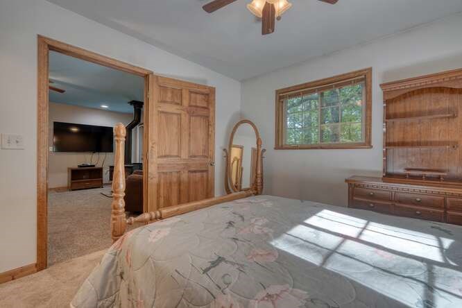 441 Foxfire Road Blairsville, GA 30512 - Photo 28 of 73 a bedroom with a bed and a flat tv screen on dresser