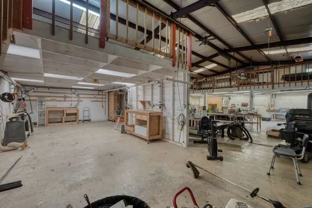 a large kitchen with granite countertop a large window and a sink