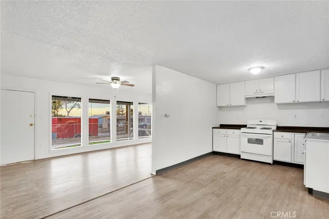 a kitchen with stainless steel appliances granite countertop a stove and a white cabinets