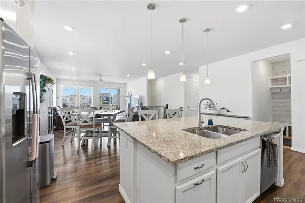 a kitchen with a kitchen island white cabinets and stainless steel appliances