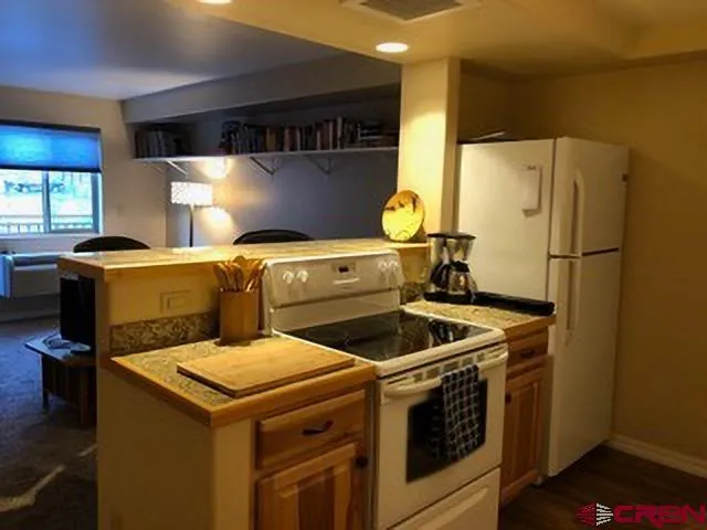 a kitchen with a stove and a refrigerator