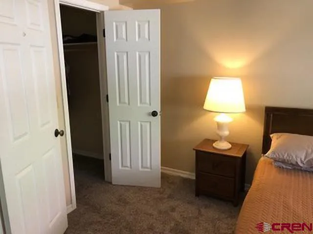 a bathroom with a granite countertop sink toilet and a mirror
