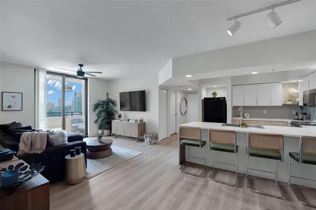 a living room with furniture flat screen tv and couches