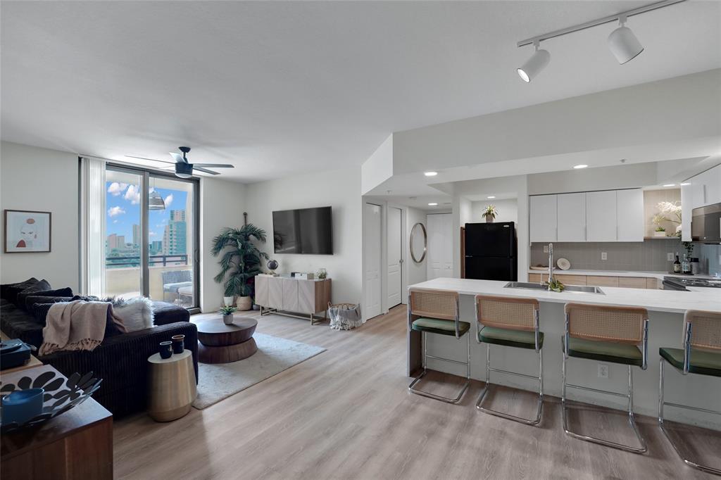 a living room with furniture flat screen tv and couches