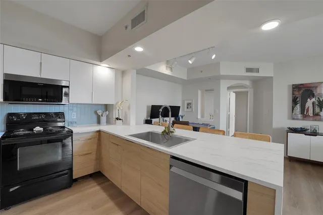 a kitchen with a sink stove and microwave