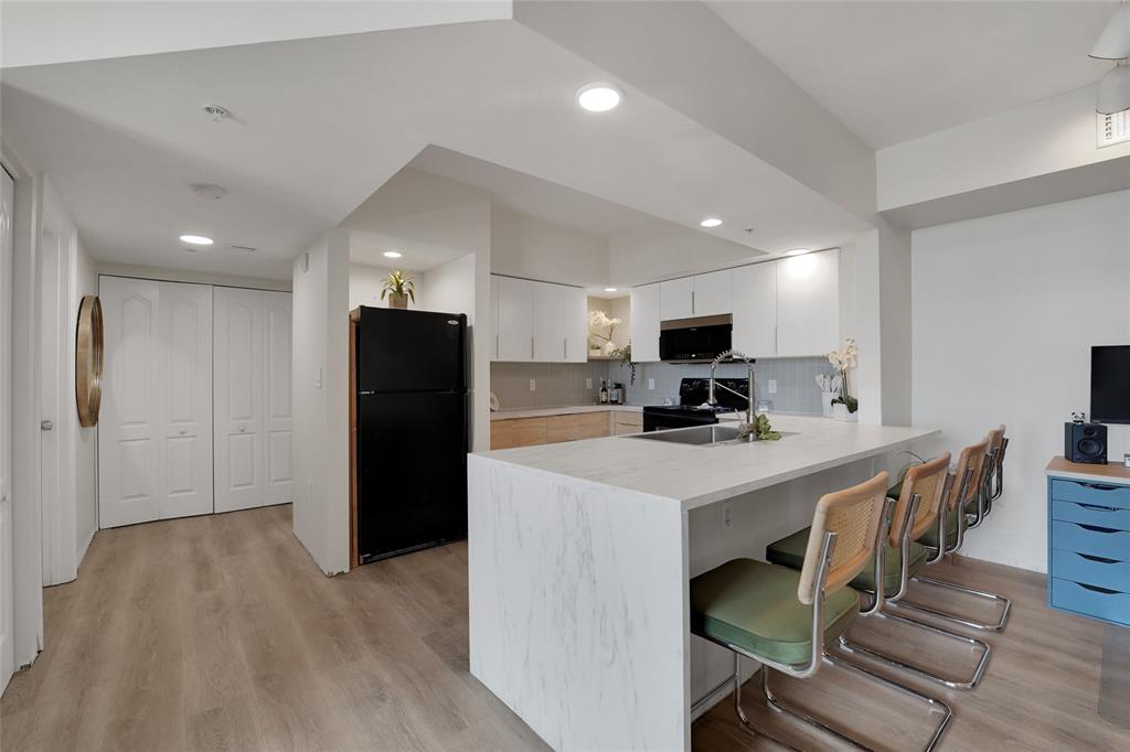 100 North Federal Highway, Unit 819 Fort Lauderdale, FL 33301 - Photo 2 of 36 a kitchen with stainless steel appliances a refrigerator and a stove top oven