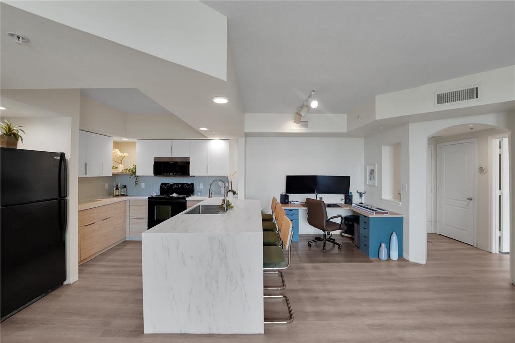 100 North Federal Highway, Unit 819 Fort Lauderdale, FL 33301 - Photo 8 of 36 a living room with stainless steel appliances furniture and a flat screen tv