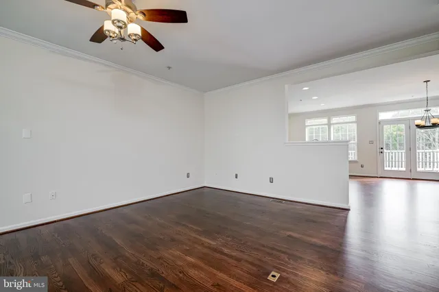 a kitchen with granite countertop wooden floors cabinets and stainless steel appliances