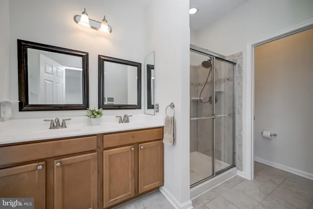 a view of a hallway with wooden floor and closet area