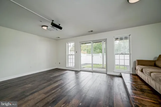 a living room with furniture and a ceiling fan