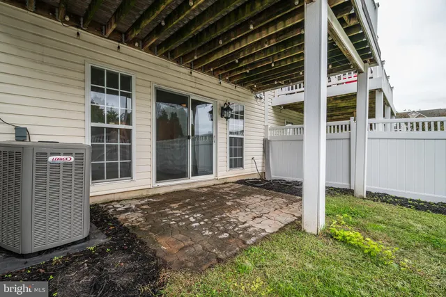 a view of a deck with two chair and wooden floor