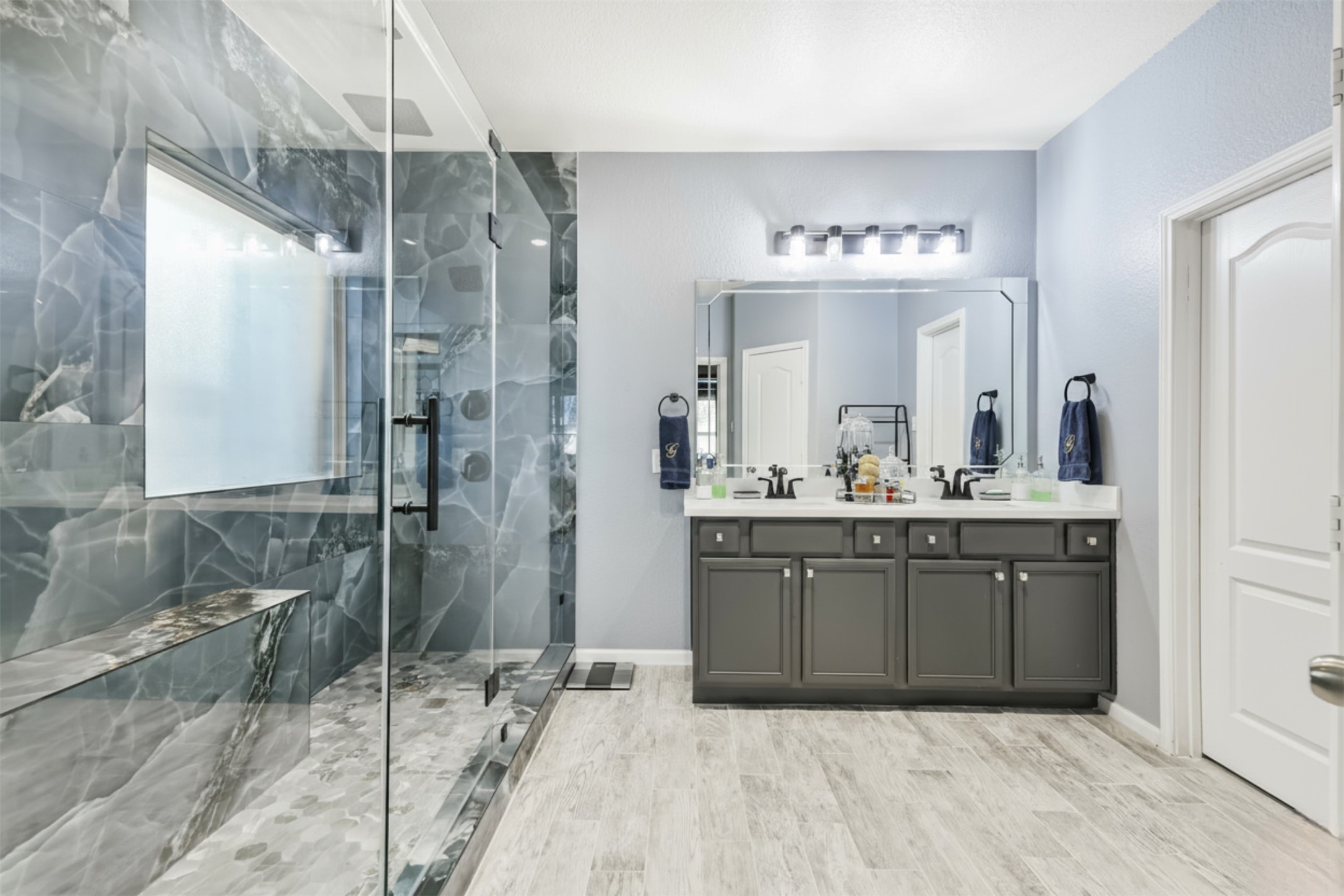 24047 Schults Meadow Lane Spring, TX 77389 - Photo 25 of 47 a bathroom with a sink mirror and a shower