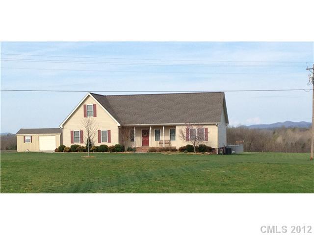 112 Tatum Road Olin, NC 28660 - Photo 1 of 16 a front view of house with a garden