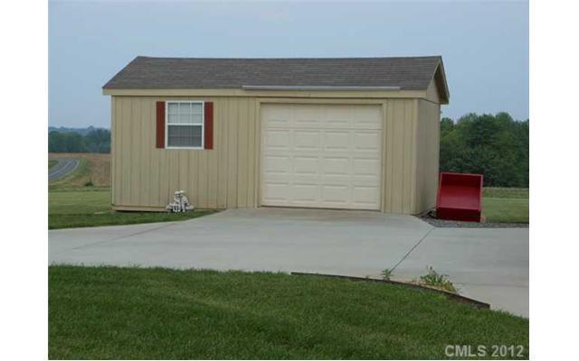 112 Tatum Road Olin, NC 28660 - Photo 14 of 16 a front view of a house with a yard