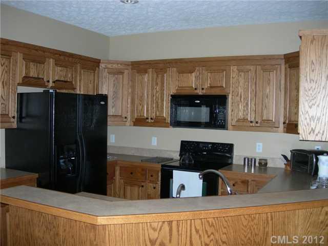 112 Tatum Road Olin, NC 28660 - Photo 6 of 16 a kitchen with stainless steel appliances granite countertop a refrigerator and a stove top oven