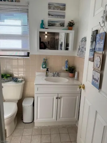 a bathroom with a sink toilet and mirror