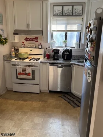 a kitchen with stainless steel appliances a stove a sink and a refrigerator