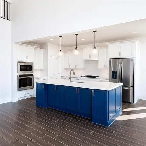 a kitchen with kitchen island granite countertop wooden cabinets and stainless steel appliances