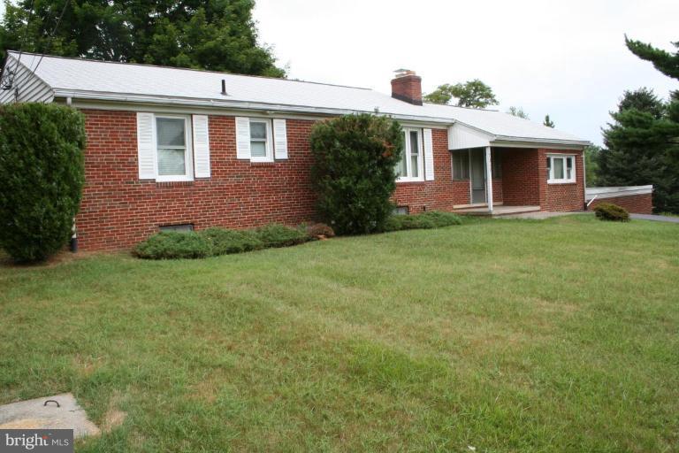 7317 Ridge Road Frederick, MD 21702 - Photo 1 of 11 a front view of a house with a garden
