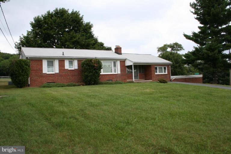 7317 Ridge Road Frederick, MD 21702 - Photo 2 of 11 a front view of a house with a garden