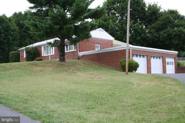 7317 Ridge Road Frederick, MD 21702 - Photo 3 of 11 a front view of a house with garden