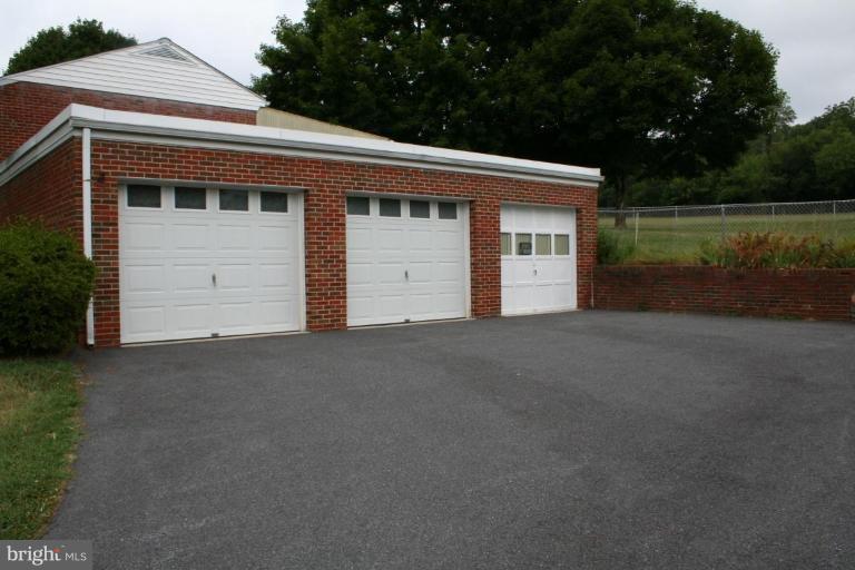 7317 Ridge Road Frederick, MD 21702 - Photo 4 of 11 a front view of a house with a yard and garage