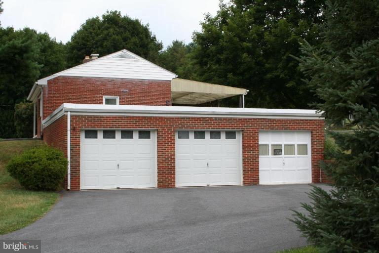7317 Ridge Road Frederick, MD 21702 - Photo 10 of 11 a front view of a house with a yard and garage