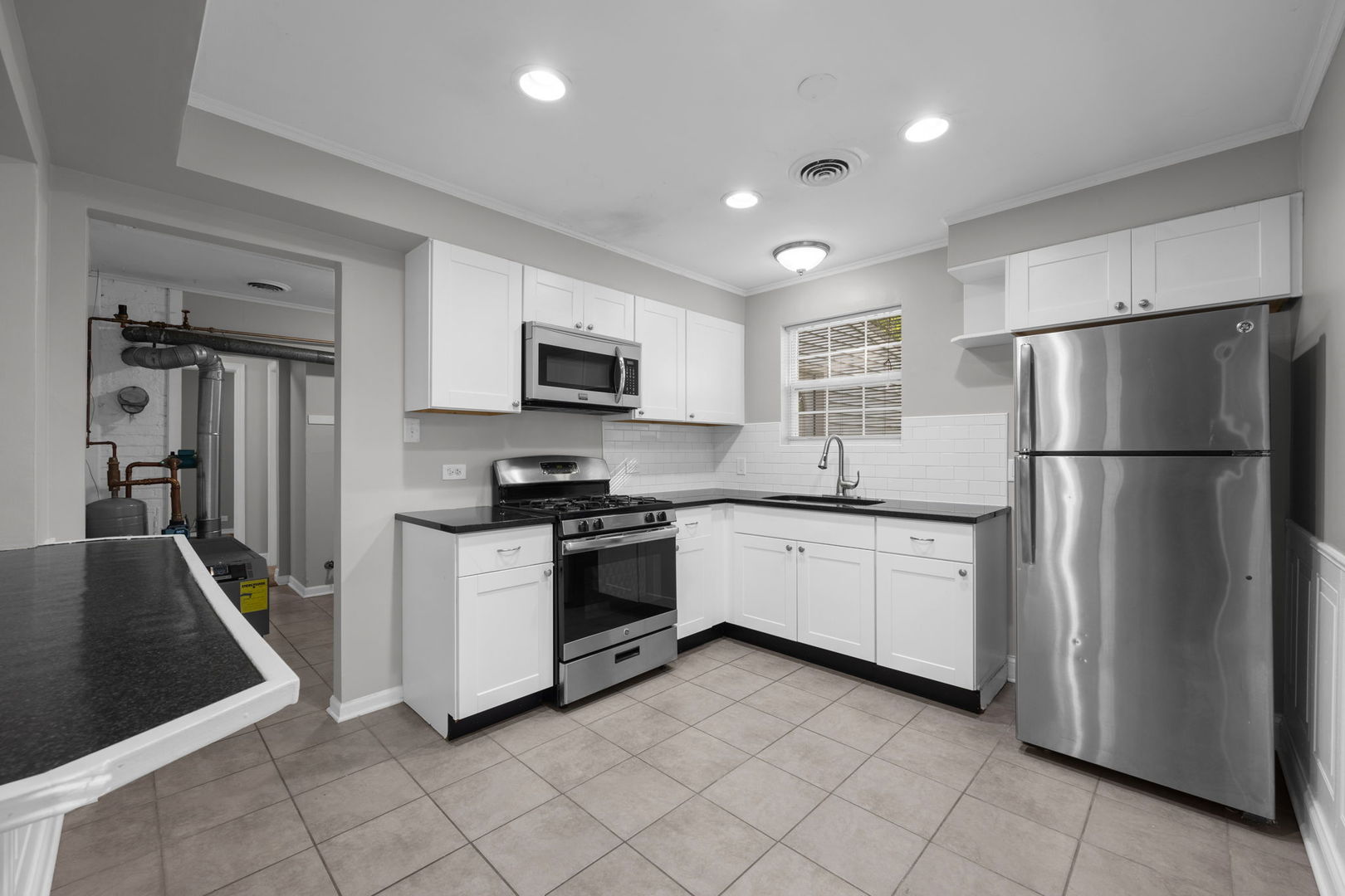 2015 Hawthorne Road Homewood, IL 60430 - Photo 5 of 16 a kitchen with sink a refrigerator and white cabinets