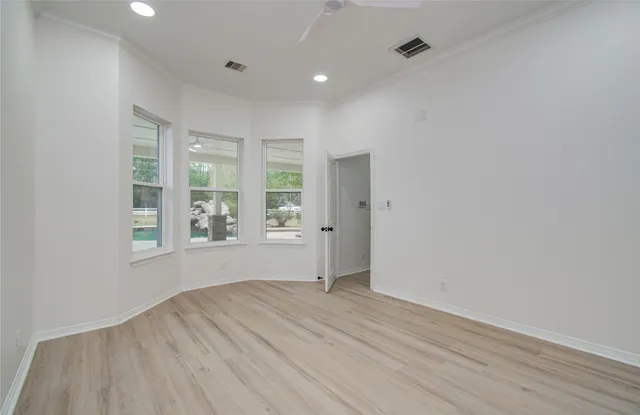 wooden floor in an empty room with a window