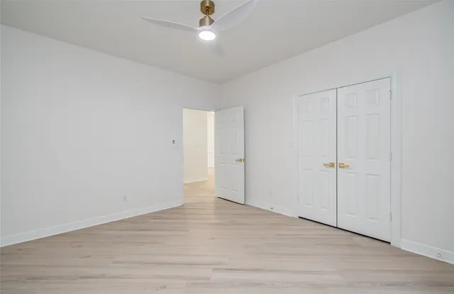 a kitchen with a sink and a wooden floor