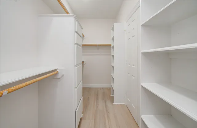 a living room with a couch and wooden floor