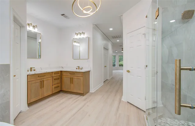 a view of a hall with floor to ceiling windows and outdoor view