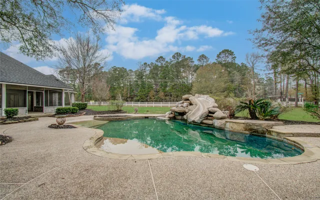 a view of an empty room with wooden floor and closet