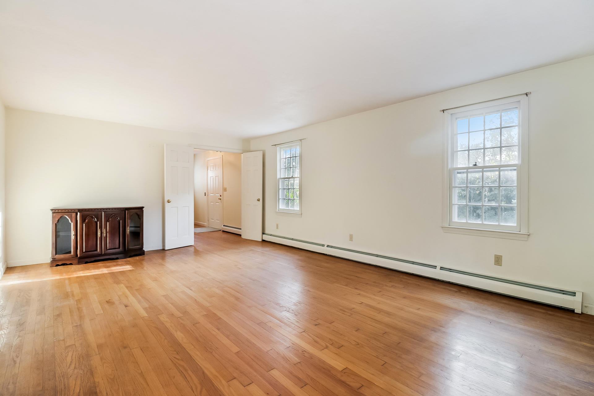 22 Joyce Anne Road Centerville, MA 02632 - Photo 10 of 18 an empty room with wooden floor and windows