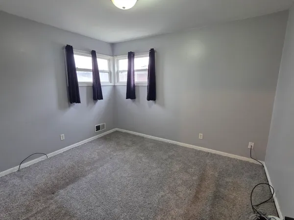 a view of an empty room with windows
