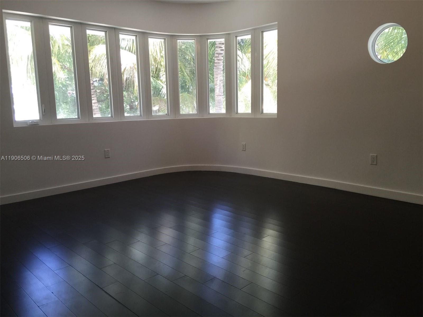 551 Michigan Avenue, Unit 122 Miami Beach, FL 33139 - Photo 3 of 7 a view of wooden floor and windows in a room