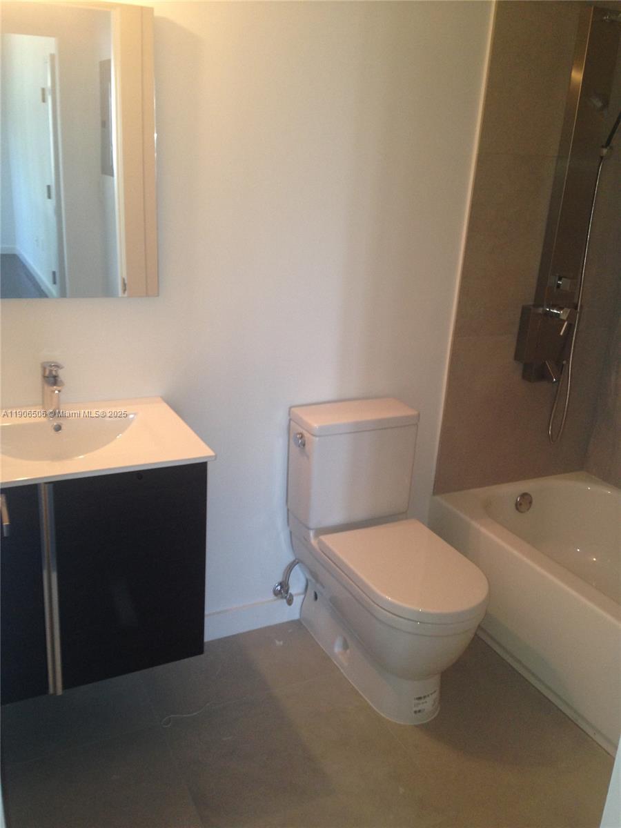 551 Michigan Avenue, Unit 122 Miami Beach, FL 33139 - Photo 7 of 7 a bathroom with a sink and a toilet